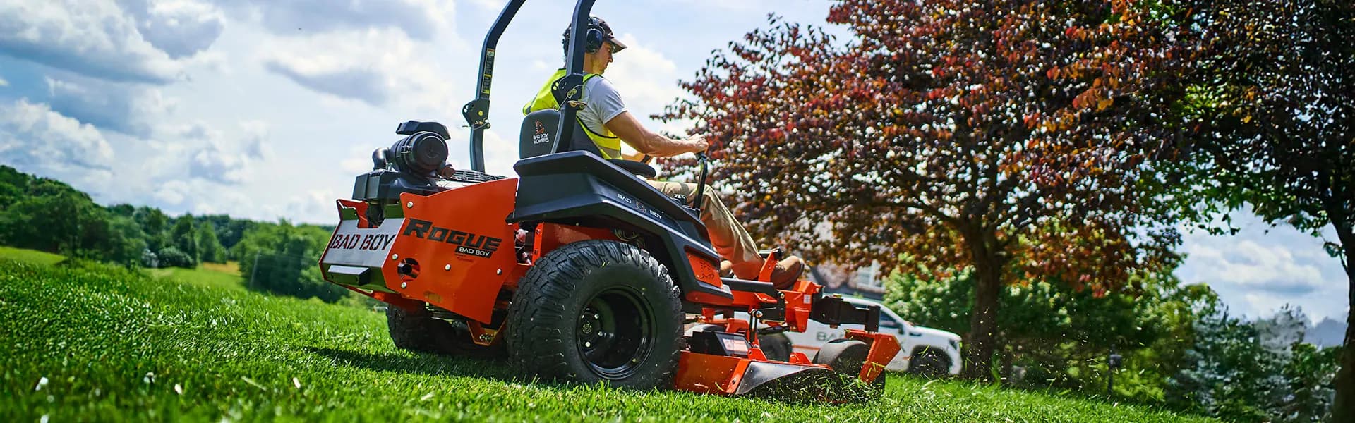 Zero-turn mower cutting a lawn on a sunny day