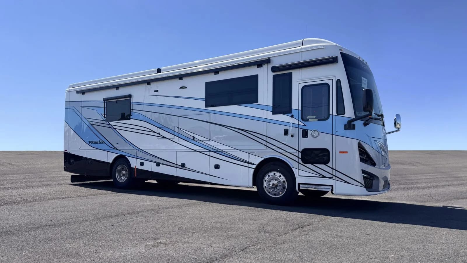 Class A motorhome parked on open asphalt under a clear sky